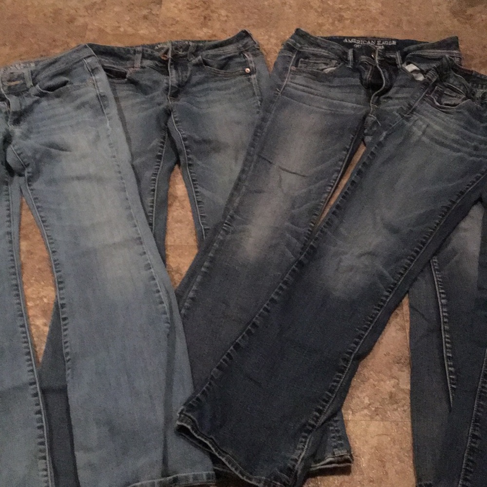 Four pairs of well worn jeans